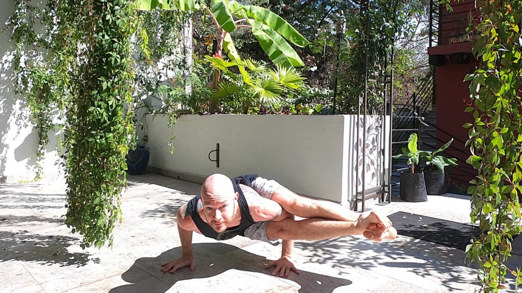Eight Angle Pose, 8 Angle Pose, Astavakrasana, Being Performed by Jai Salsbery at the Vallarta Breeze Yoga Puerto Vallarta Yoga Studio