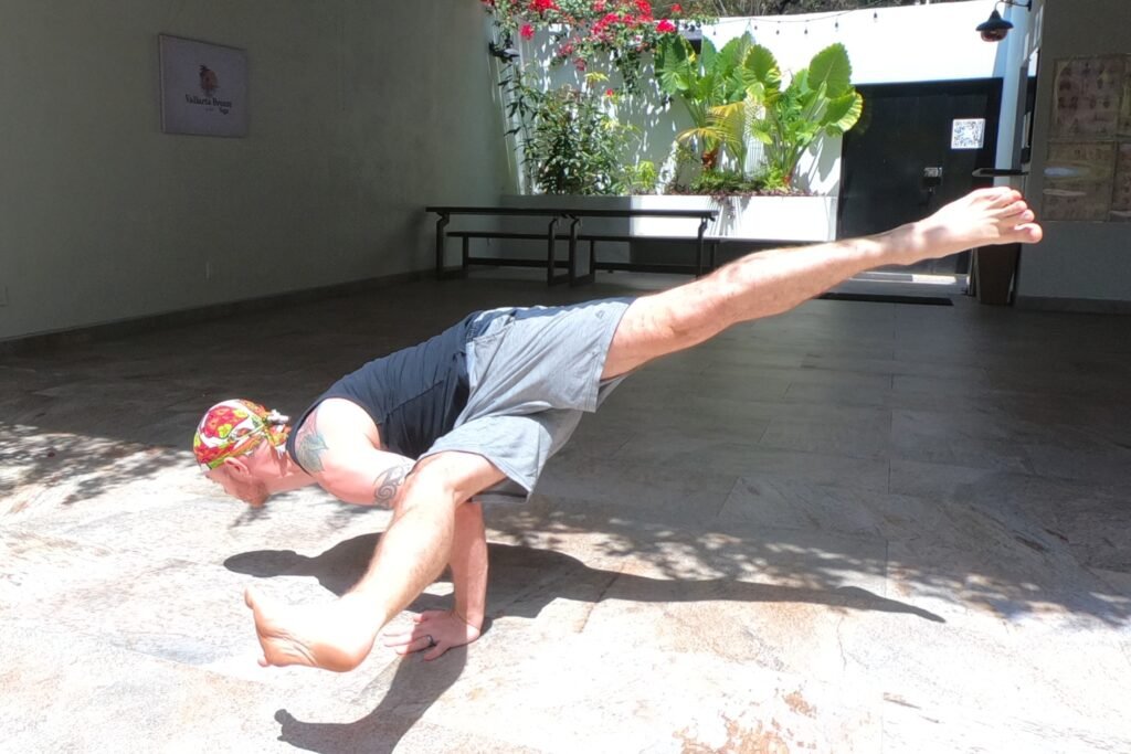 Eka Pada Koundinyasana 1 being performed by Yoga Teacher/Trainer Jai Salsbery E-RYT500 at the Vallarta Breeze Yoga Puerto Vallarta Yoga Studio