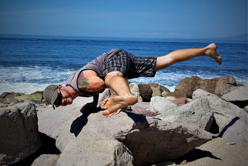 Eka Pada Koundinyasana II being performed by Yoga Teacher/Trainer Jai Salsbery E-Ryt500 at the Vallarta Breeze Yoga Puerto Vallarta Yoga Studio.